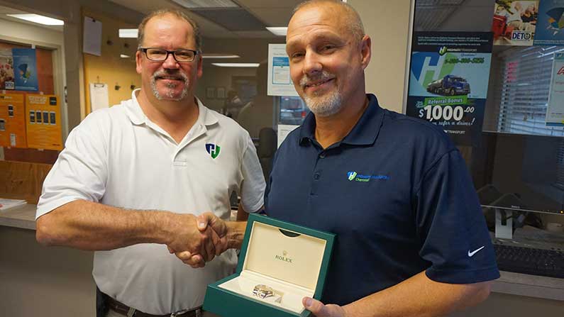 Greg Watkins presents 20-year Rolex to Rick Lusby