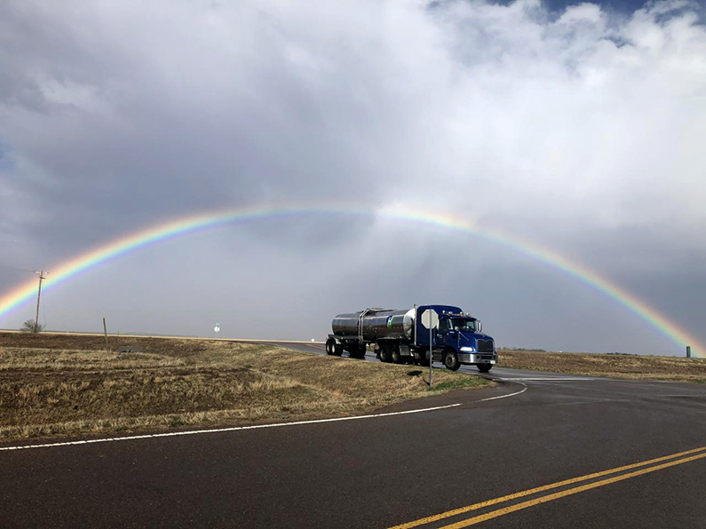 Full rainbow over Highway Transport tanker truck