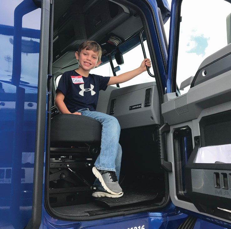 elementary school kid in the cab of truck